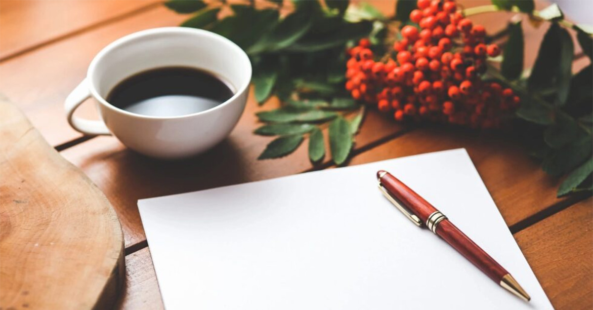 Contact Us - Photo of pen, paper, and cup of coffee. Coffee Party USA